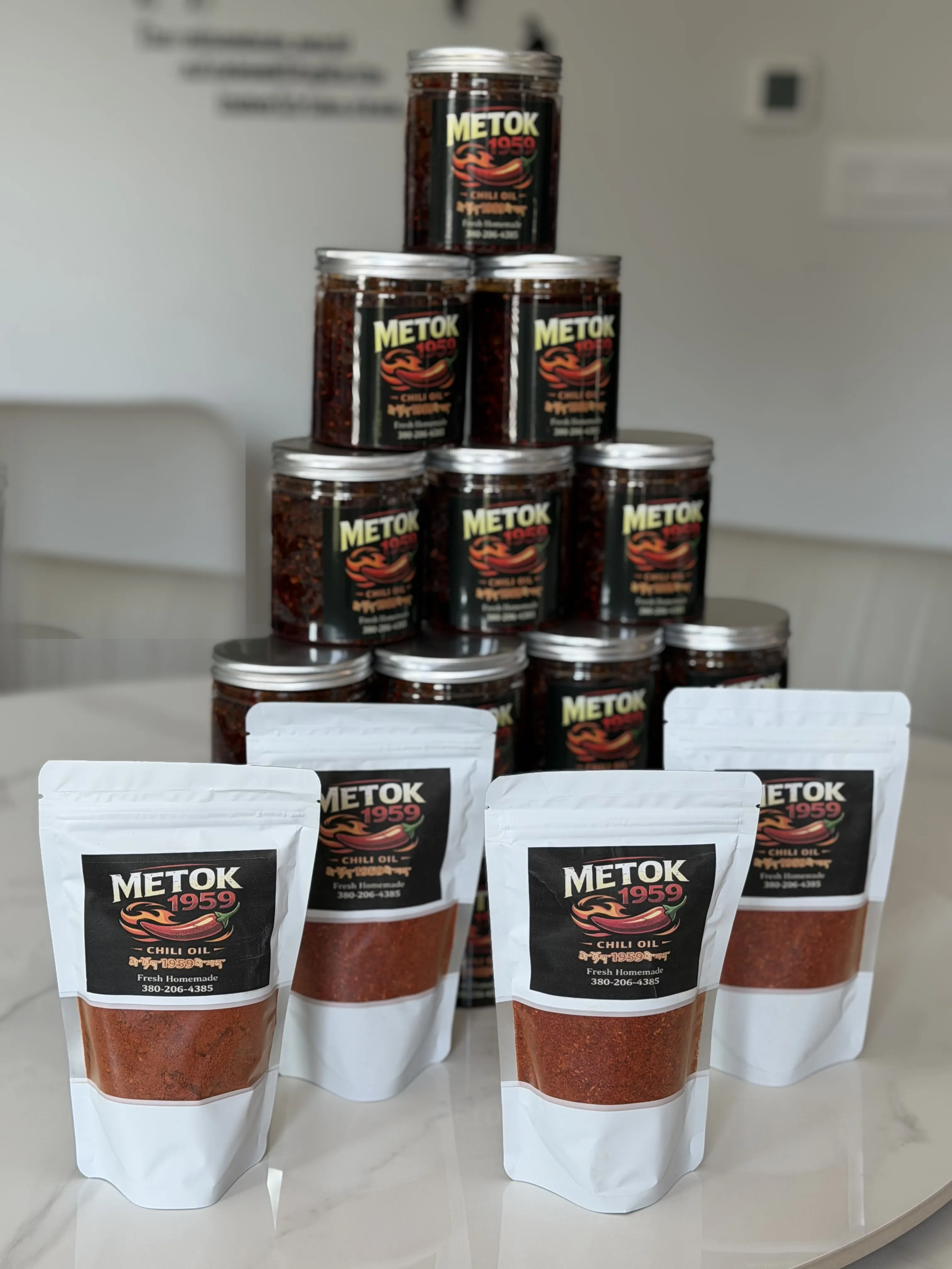 Metok 1959 chili oil jars stacked behind pouches of chili powder